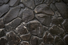 Black stone wall texture. Bali. Indonesia